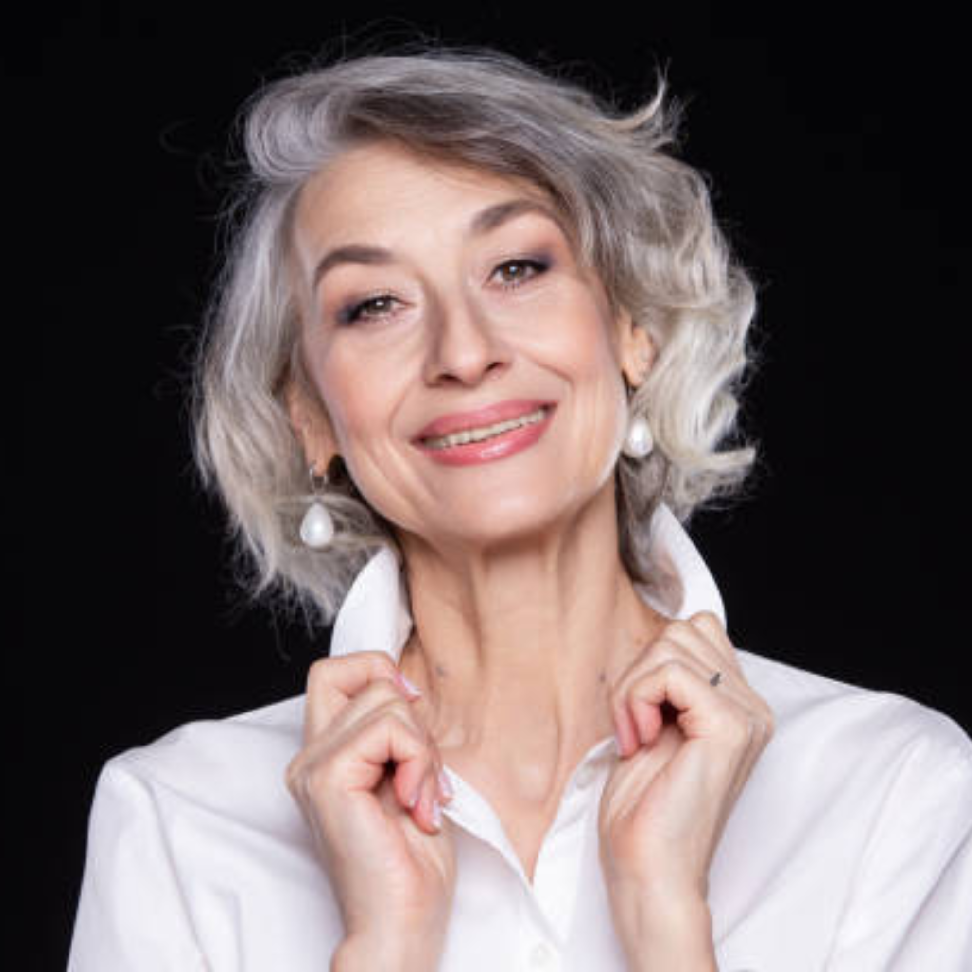 woman holding the collar of her white shirt