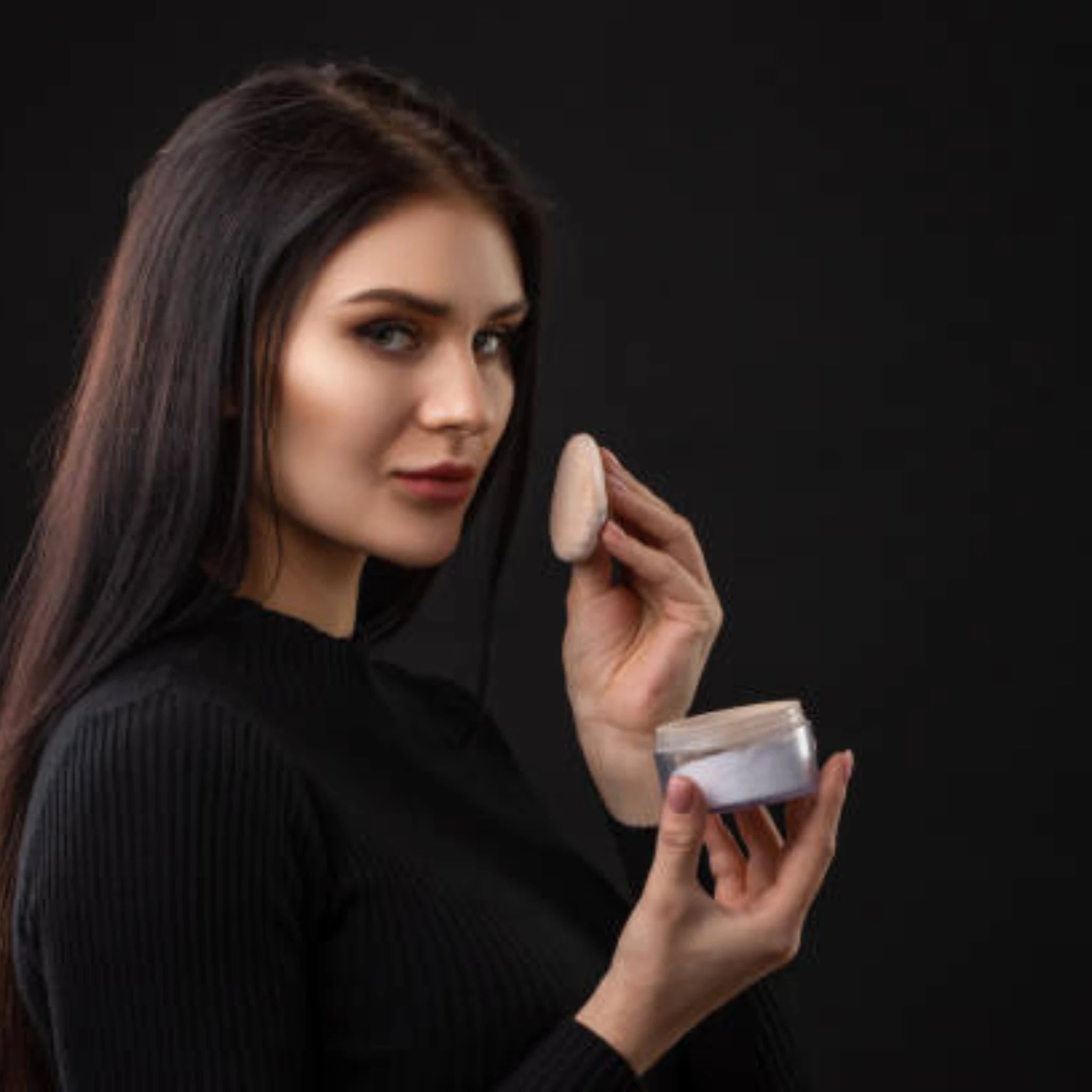 woman holding face powder