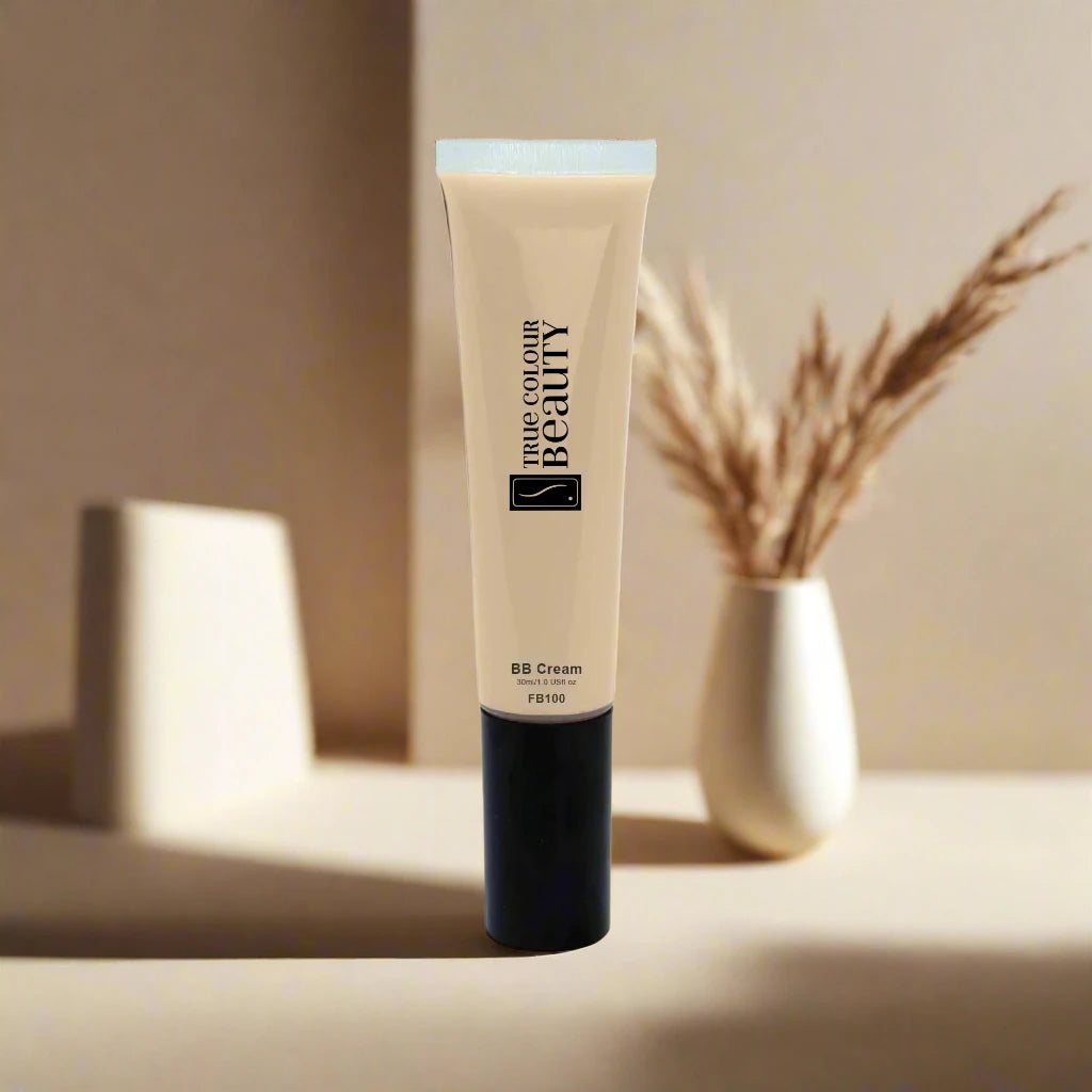 BB Cream - Wheat tube with black cap on white surface, paired with a white vase containing dried plants, reflecting True Colour Beauty's eco-conscious skincare ethos.