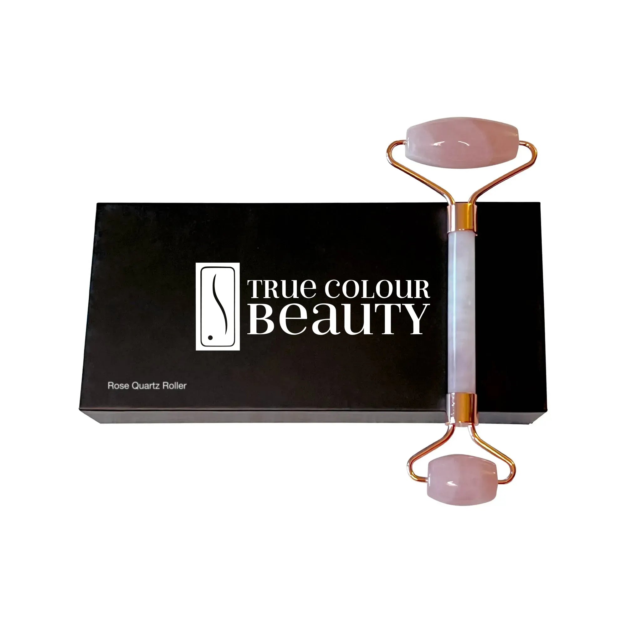 True Radiance Rose Quartz Roller on a black box, designed to detoxify and rejuvenate skin, enhancing skincare product absorption and reducing puffiness with naturally cool stone.