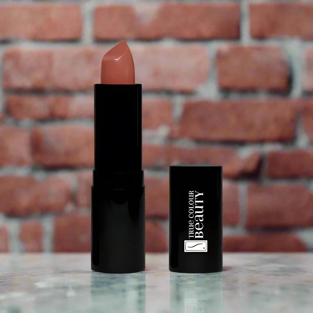 Elegant Rose lipstick displayed on a marble countertop with soft lighting, highlighting its chic rose shade