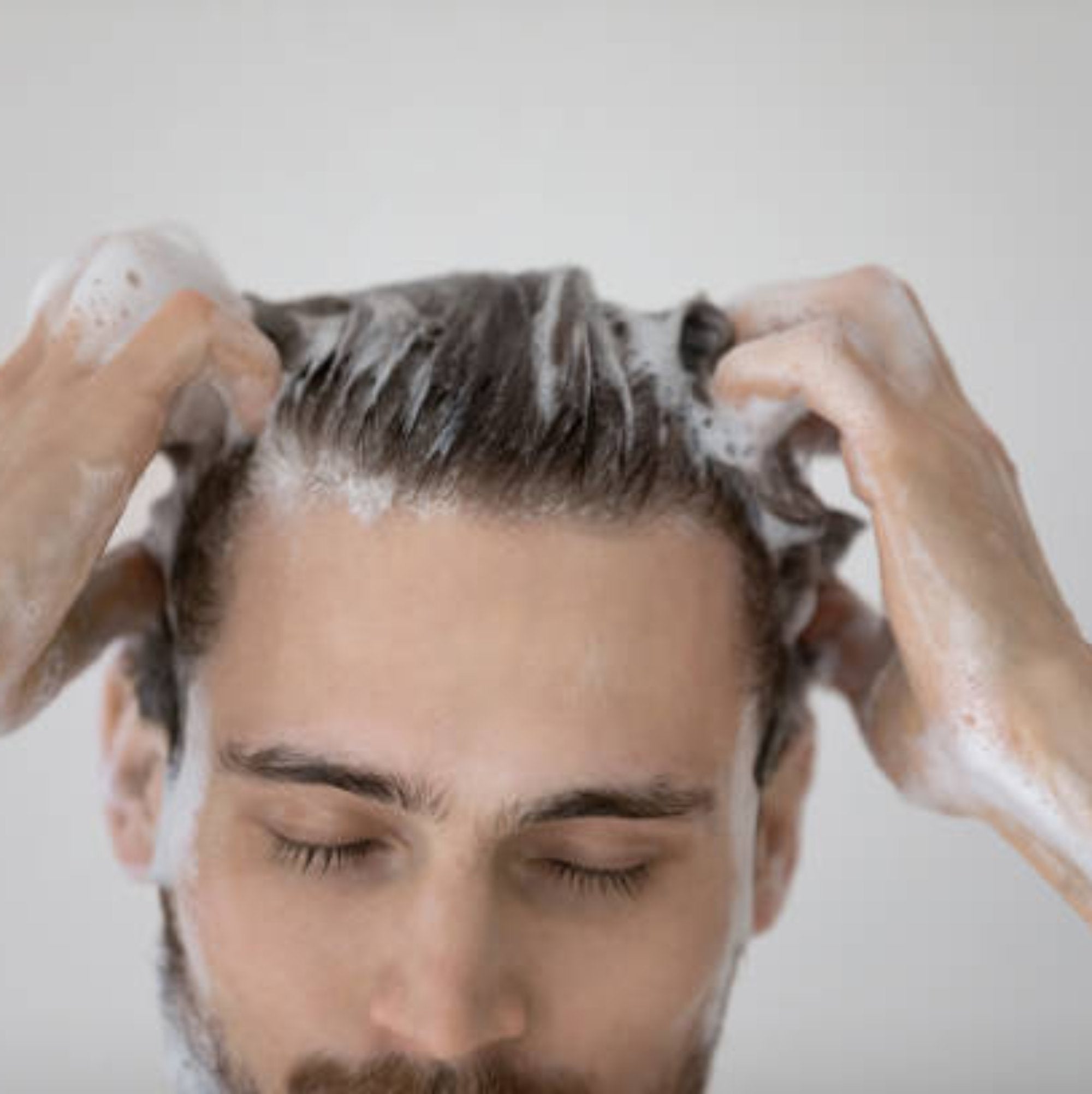 Close-up of TCB Men's Daily Shampoo model, showcasing its lightweight, easy-lather formula for a thorough cleanse.