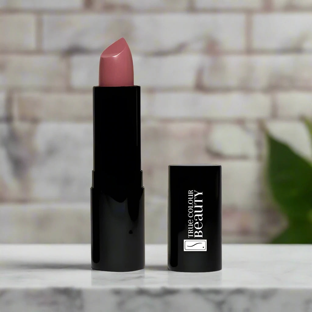 Parisian Petal lipstick placed on a marble counter, emphasizing its elegant pink tone