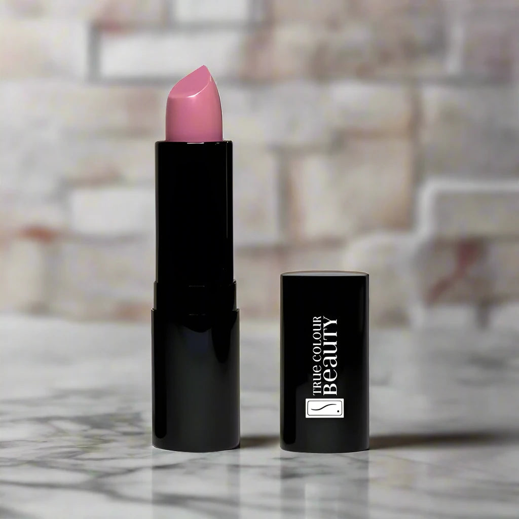 Tube of lipstick on a white marble counter in shade Radiant Blush by True Colour Beauty.