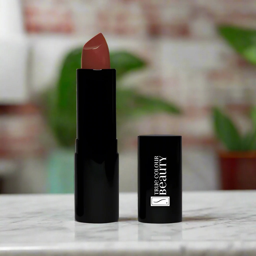 Scarlet Allure lipstick placed on a marble countertop, complementing the deep red tone.