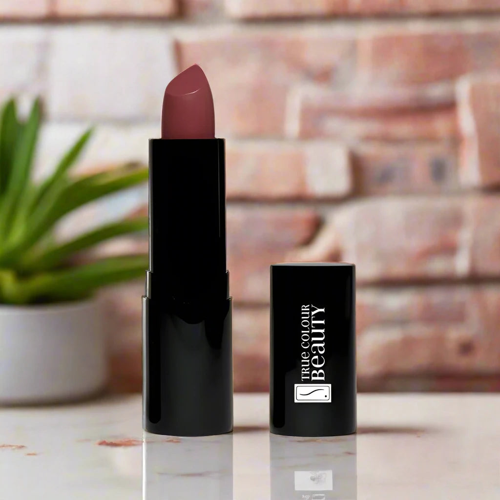 true Luxury Lipstick on a white countertop with a brick wall background